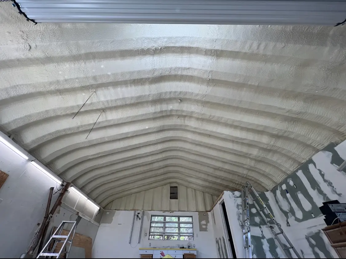 Spray polyurethane foam applied to the underside of a metal roof deck in Krum